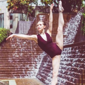 Ballet dancer en pointe by waterfall fountain